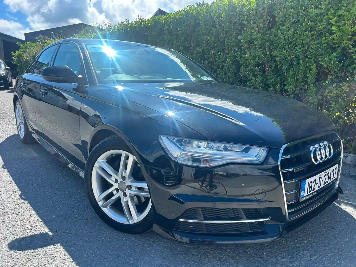 Black Audi A6 S line in sunlight, front view with the four rings, at RS Motors, Clonakilty